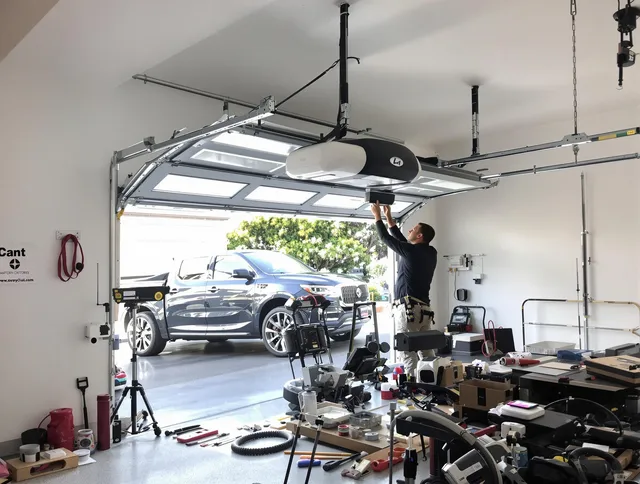 Southbury Garage Door Repair specialist installing smart garage door opener system in Southbury home